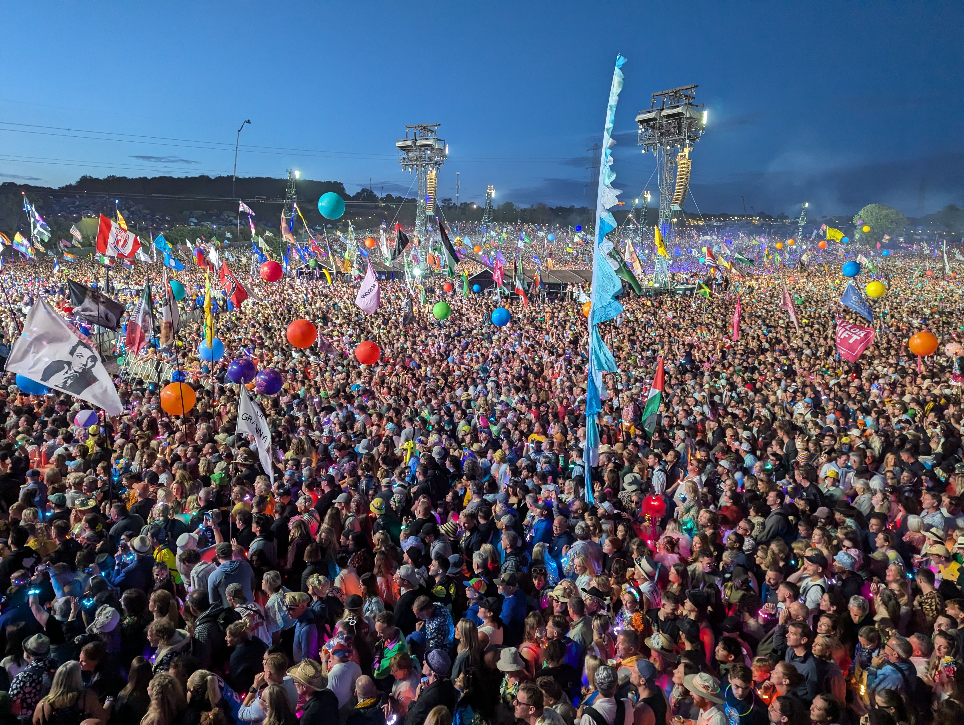 A large, vibrant crowd of people at a festival